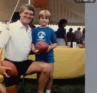 Photo of an older person and a younger person holding footballs