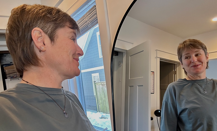 Photo of Molly Booker looking in the mirror