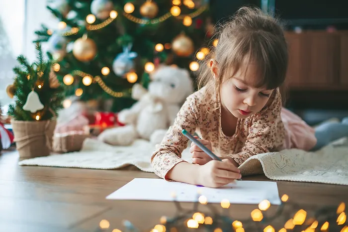 Photo of a young person writing a letter to Santa