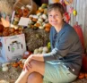 Photo of Molly Booker sitting on a hay bale