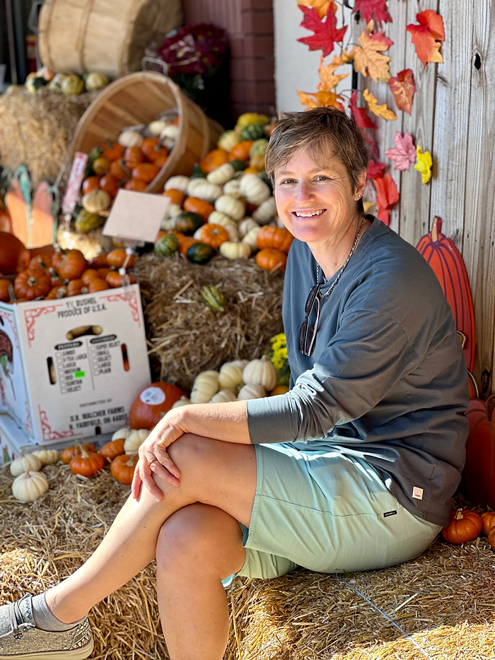 Photo of Molly Booker sitting on a hay bale